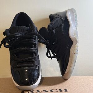 Air Jordan 11s Low 2.5y Black and White Athletic Sneakers